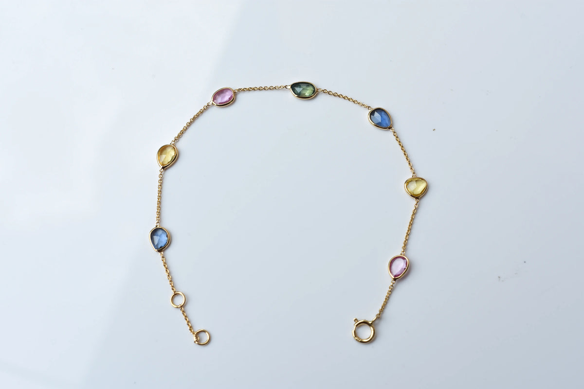 18K gold bracelet with single oval multi-color sapphire stations