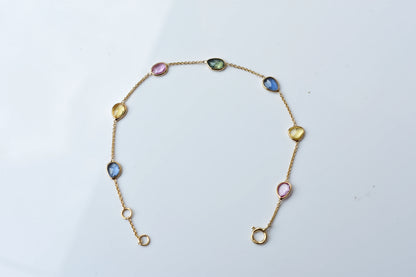 18K gold bracelet with single oval multi-color sapphire stations