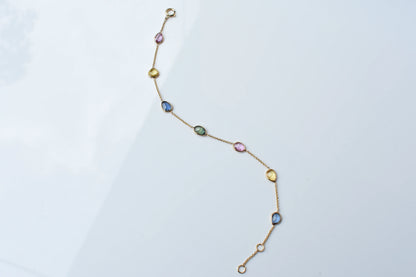 18K gold bracelet with single oval multi-color sapphire stations