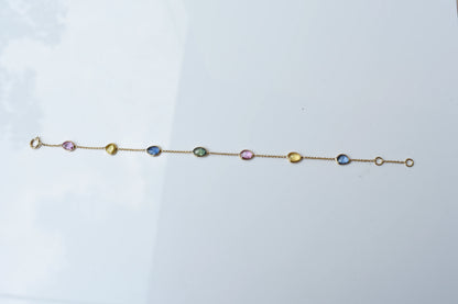 18K gold bracelet with single oval multi-color sapphire stations