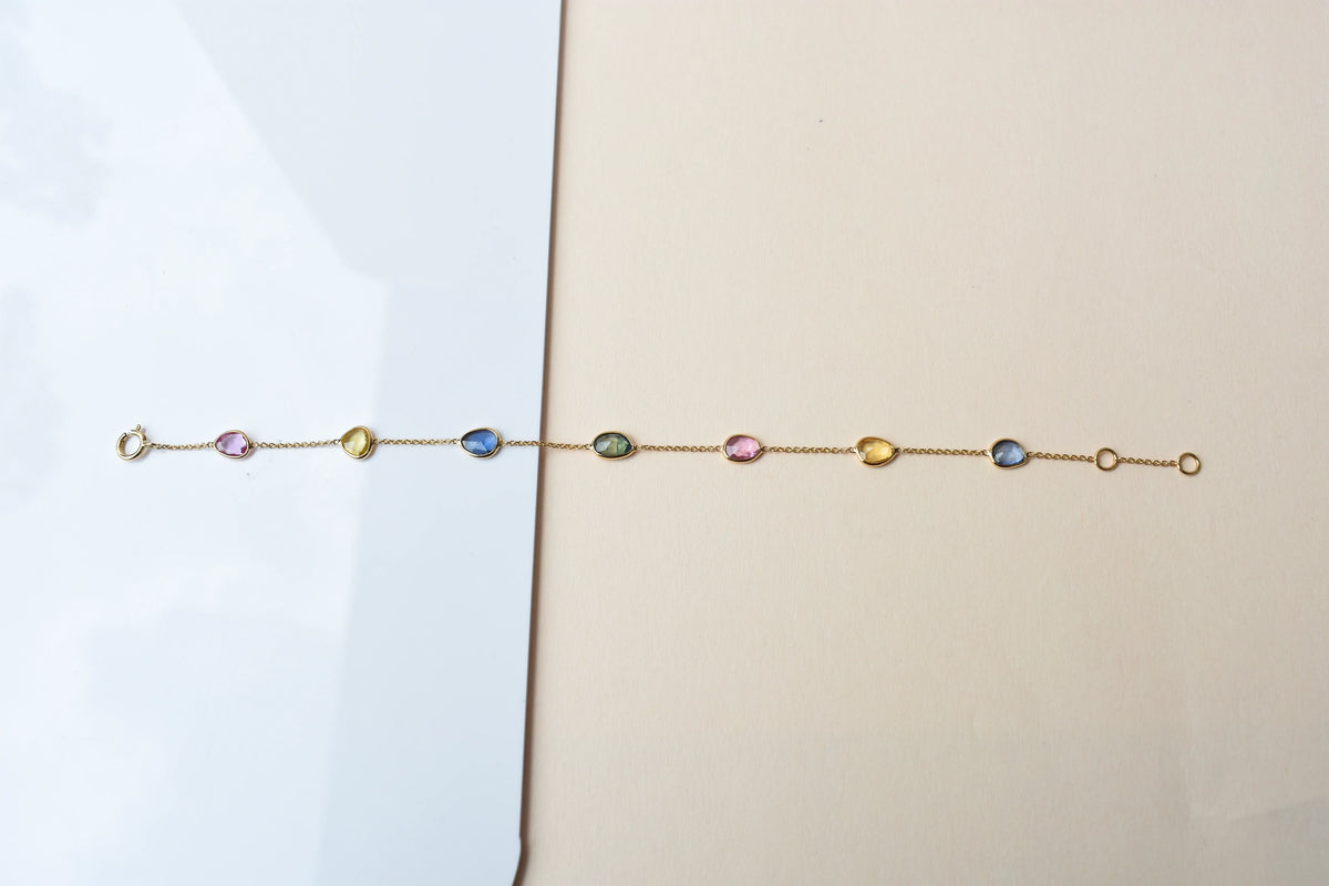 18K gold bracelet with single oval multi-color sapphire stations