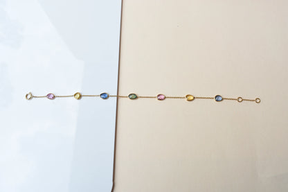 18K gold bracelet with single oval multi-color sapphire stations