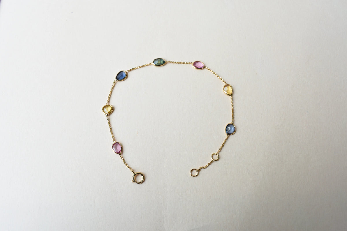 18K gold bracelet with single oval multi-color sapphire stations