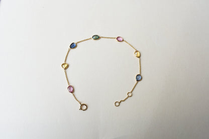 18K gold bracelet with single oval multi-color sapphire stations