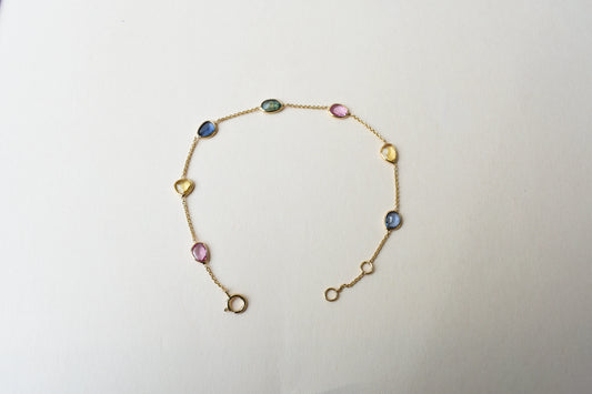 18K gold bracelet with single oval multi-color sapphire stations