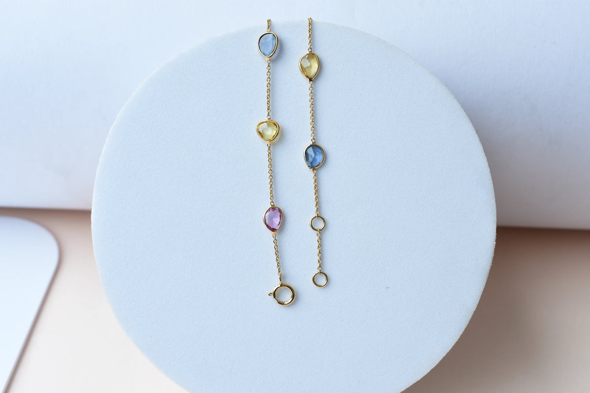 18K gold bracelet with single oval multi-color sapphire stations