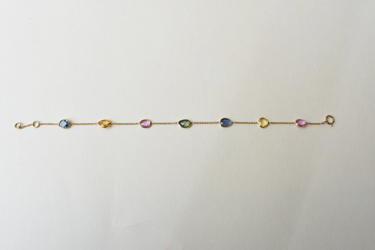 18K gold bracelet with single oval multi-color sapphire stations