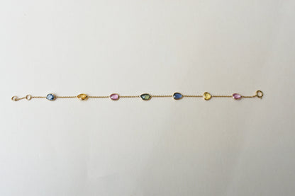 18K gold bracelet with single oval multi-color sapphire stations
