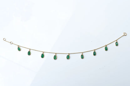18K gold bracelet with oval emerald drops in fringe design