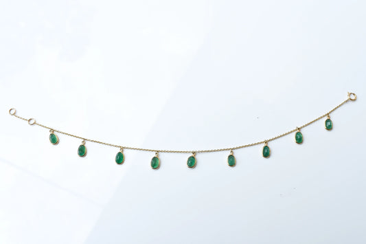 18K gold bracelet with oval emerald drops in fringe design