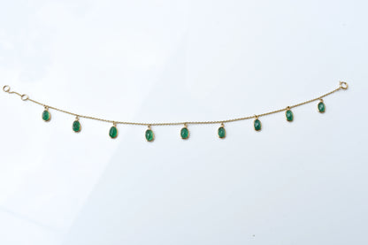 18K gold bracelet with oval emerald drops in fringe design