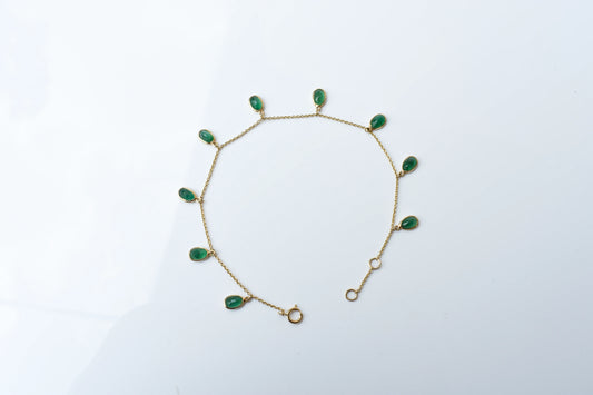18K gold bracelet with oval emerald drops in fringe design