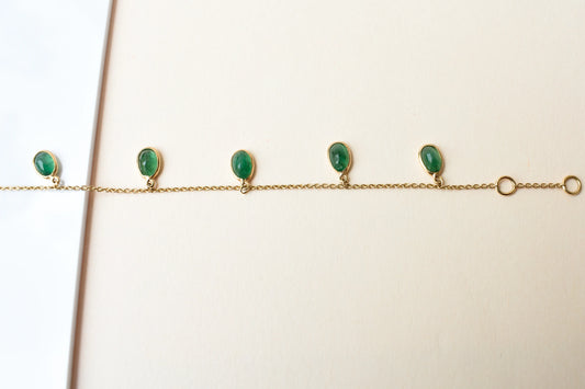 18K gold bracelet with oval emerald drops in fringe design