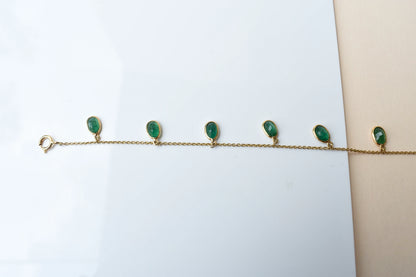 18K gold bracelet with oval emerald drops in fringe design