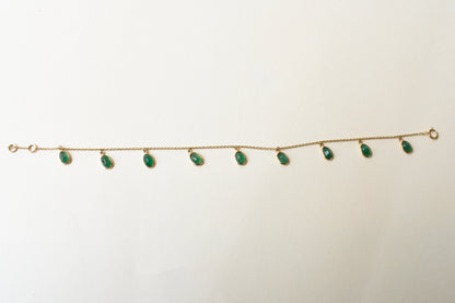18K gold bracelet with oval emerald drops in fringe design