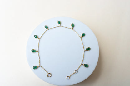 18K gold bracelet with oval emerald drops in fringe design