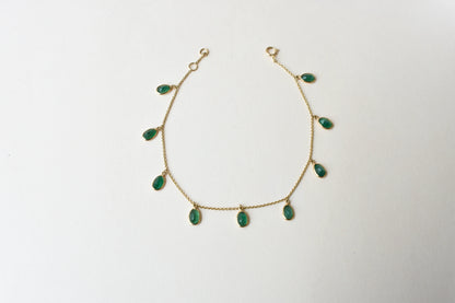 18K gold bracelet with oval emerald drops in fringe design