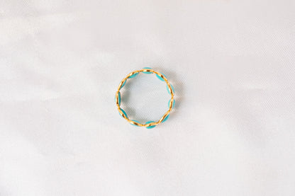 Oval cabochon turquoise gemstone eternity ring in gold with bezel setting