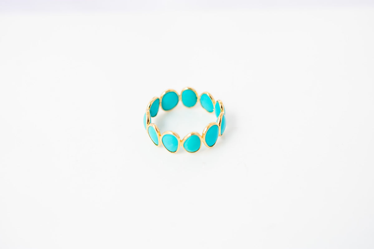 Oval cabochon turquoise gemstone eternity ring in gold with bezel setting