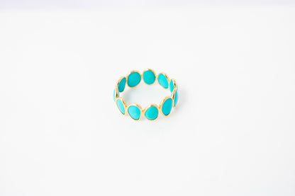 Oval cabochon turquoise gemstone eternity ring in gold with bezel setting
