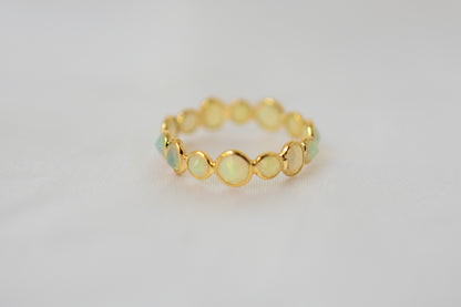 Cabochon opal gemstone eternity ring in 18K gold with bezel setting