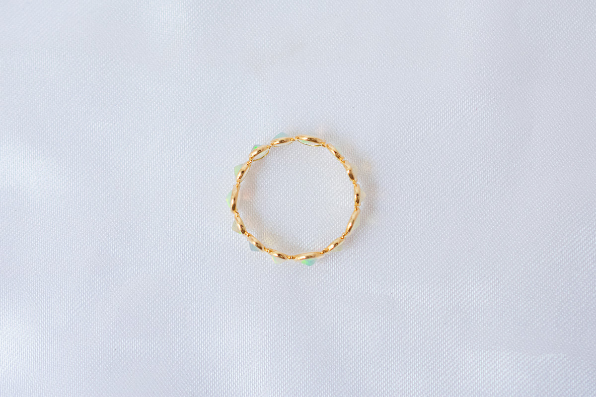 Cabochon opal gemstone eternity ring in 18K gold with bezel setting