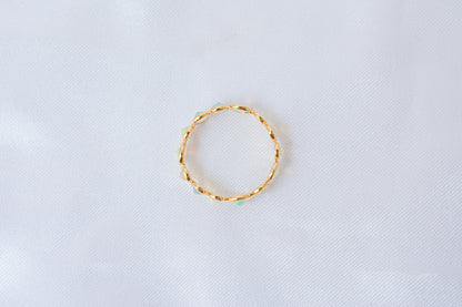 Cabochon opal gemstone eternity ring in 18K gold with bezel setting