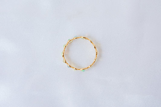 Cabochon opal gemstone eternity ring in 18K gold with bezel setting