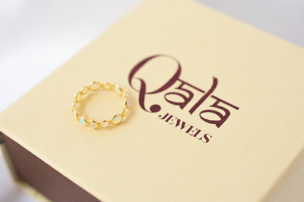 Cabochon opal gemstone eternity ring in 18K gold with bezel setting