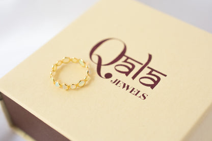 Cabochon opal gemstone eternity ring in 18K gold with bezel setting