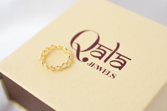Cabochon opal gemstone eternity ring in 18K gold with bezel setting