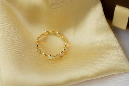 Cabochon opal gemstone eternity ring in 18K gold with bezel setting