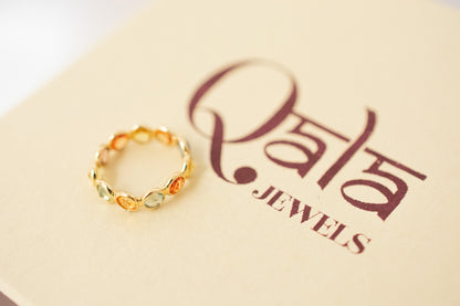 Round-cut multicolor sapphire eternity ring in 18K gold with bezel setting