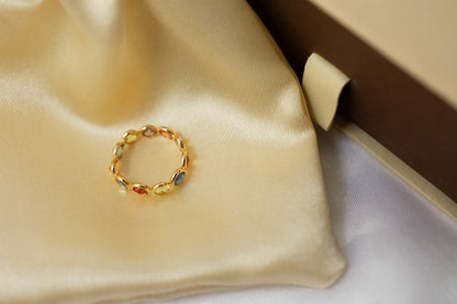 Round-cut multicolor sapphire eternity ring in 18K gold with bezel setting