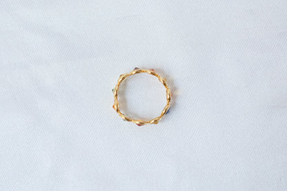 Round-cut multicolor sapphire eternity ring in 18K gold with bezel setting