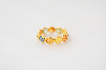 Round-cut multicolor sapphire eternity ring in 18K gold with bezel setting