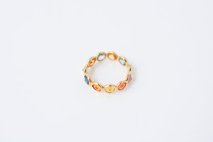 Round-cut multicolor sapphire eternity ring in 18K gold with bezel setting