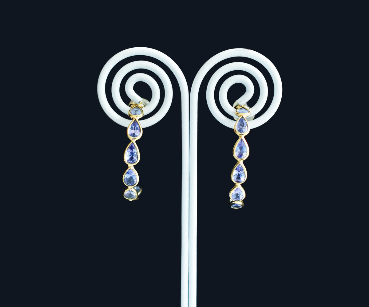 18K gold hoop earrings with graduated pear-cut tanzanite
