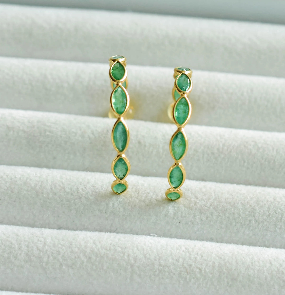 18K gold hoop earrings with marquise-cut emeralds