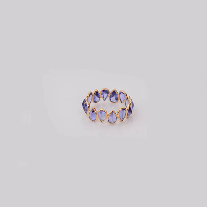 18K gold eternity ring with bezel-set pear-cut tanzanite stones
