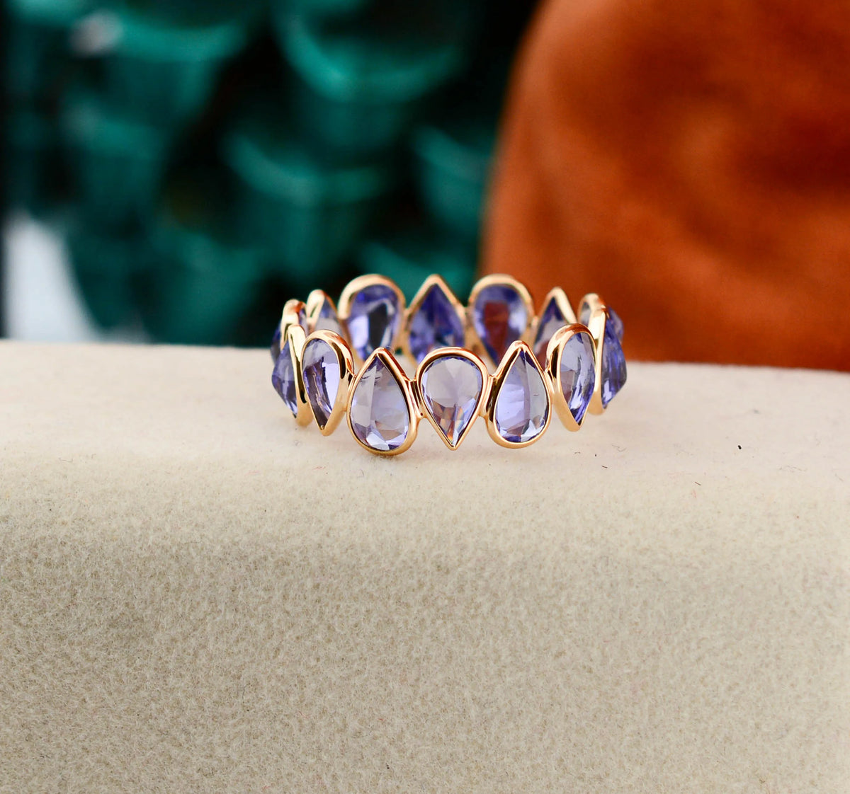 18K gold eternity ring with bezel-set pear-cut tanzanite stones