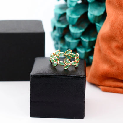 18K gold eternity ring with marquise-cut emeralds in a floral vine design