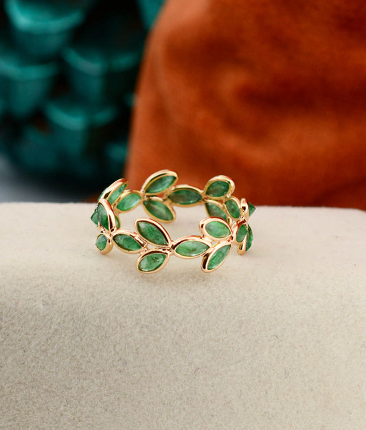 18K gold eternity ring with marquise-cut emeralds in a floral vine design