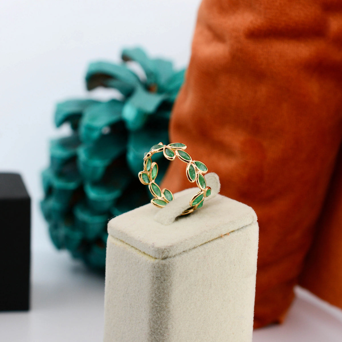 18K gold eternity ring with marquise-cut emeralds in a floral vine design
