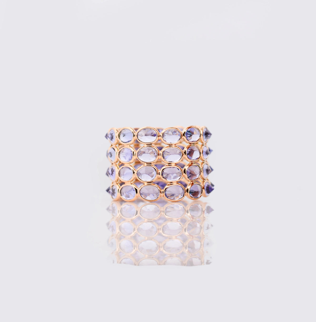 18K gold wide cocktail ring with bezel-set oval tanzanite in a honeycomb pattern