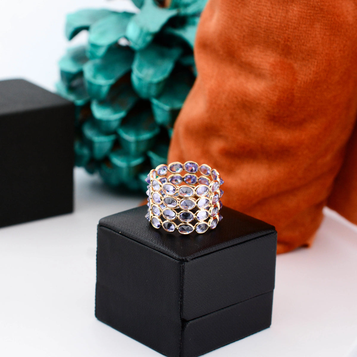 18K gold wide cocktail ring with bezel-set oval tanzanite in a honeycomb pattern