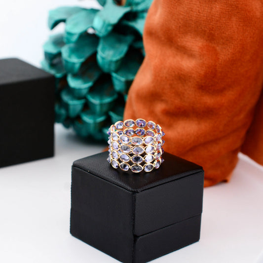 18K gold wide cocktail ring with bezel-set oval tanzanite in a honeycomb pattern