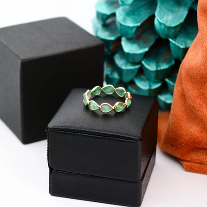 18K gold eternity ring with alternating pear-cut emeralds
