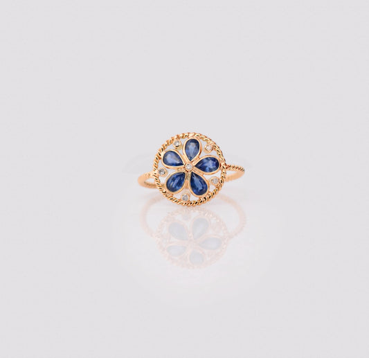 18K gold flower cluster ring with blue sapphire petals and a center diamond