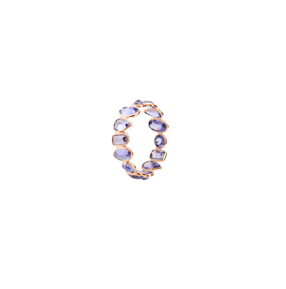 18K gold eternity ring with mixed-cut tanzanite stones in a mosaic pattern